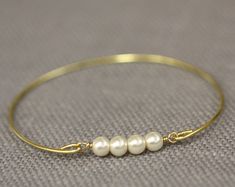 Three Pearl Bracelet Bangle Past Present Future Jewelry | Etsy Gold Pearl Bangle For Gift, Gold Pearl Bangle As Gift, Gold Pearl Bangle Perfect As A Gift, Gold Wire Wrapped Pearl Bracelet For Weddings, Future Jewelry, Hand Band, Pearl Bangle, Past Present Future, Ivory Pearl