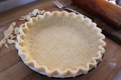 an uncooked pie sitting on top of a wooden table