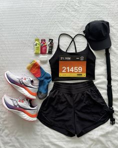 a woman's running outfit, hat, and shoes on a bed with the price tag displayed