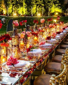 a long table is set up with candles and flowers on it for a formal dinner