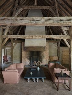 a living room filled with furniture and a fire place in the middle of a building