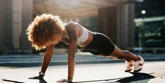 a woman is doing push ups on the ground