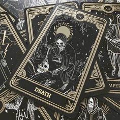 some black and gold playing cards with skeletons on them