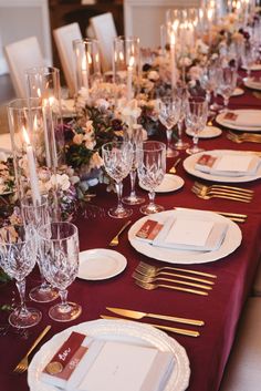 the table is set with white and gold place settings