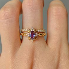 Gorgeous vintage inspired Alexandrite ring set ✧ Sterling silver (925) or 14K Gold or 14K Rose gold ✧ Accented with natural quartz diamonds This gorgeous, timeless ring features a stunning alexandrite and natural crystals.  ✧ Shape: Oval ✧ Color: Purple/maroon/purple (color changes in different lighting)  ✧ Carat Weight: 0.53ct.(approx.) ✧ Gemstone Origin: Brazil ✧ Sizes 3.75-11.25 ✧ This ring set will arrive ready to gift in a Kherish Box. ✧ Due to the nature of the handmade process, each piece Heirloom Rose Gold Birthstone Ring With Gemstone, Heirloom Rose Gold Birthstone Ring, Heirloom Style Stackable Rings With Center Stone, Heirloom Rose Gold Cluster Ring With Gemstone, Heirloom Rose Gold Rings With Gemstone, Heirloom Rose Gold Gemstone Rings, Heirloom Stackable Rings With Center Stone As Gift, Engagement Stack, Gold Rings For Women