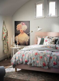 a room with a bed, table and pictures on the wall