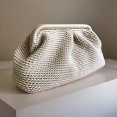 a white purse sitting on top of a counter