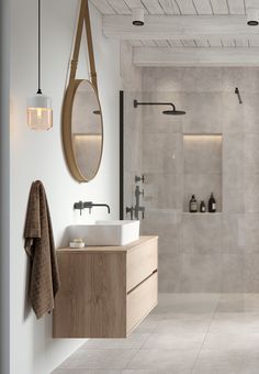 a bathroom with two sinks and a large mirror on the wall next to a walk in shower