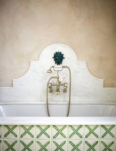 a bathtub and sink in a bathroom with green tile