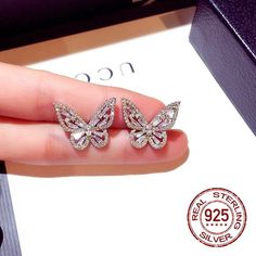 🦋✨ Icy Butterfly Earring ✨🦋 This elegant butterfly earring is totally handmade with high quality 925 Sterling Silver, Cubic Zirconia and Baguette crystals. All stones are beautifully placed by professional jeweler. Clean materials, free from harmful substances, safe for all skin types. It's a great gift for ladies who like to wear jewelry daily. ✅ Handmade ✅ Water/Sweet Resistant  ✅ Anti-Tarnish Quality ✅ Hypoallergenic  We hope you enjoy your jewelry, but if for any reason you are unhappy, pl Wedding Butterfly, Butterfly Earring, Bling Earrings, Butterfly Earrings Stud, Classic Necklace, Party Earrings, Chains Necklaces, Mood Tracker, Cross Border