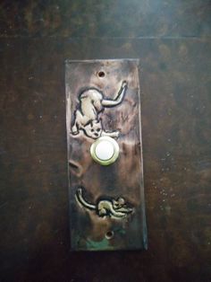 a metal switch plate with an animal design on it