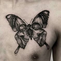 a black and white image of a butterfly with skulls on it's back shoulder