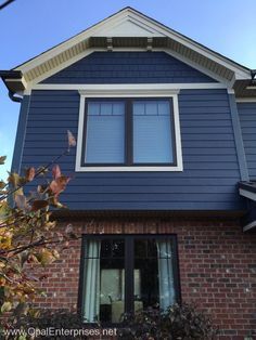 a blue house with white trim and windows