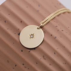 The Chiara necklace is a light gold round disc necklace that you just NEED. Wheather you wear it alone or stacked, with your another necklace or bare alone- it's perfect. Add a personal touch to your Chiara necklace with an engraved portrait of a loved one on one side and their name engraved on the opposite side. If you can dream it- we can make it happen. All features can be customized! Talk to us, we love making custom designs. Our jewelry is carefully handmade in our atelier To order by phone Diamond Necklace With Coin Pendant As Gift, Round Diamond Necklace With Coin Pendant As Gift, Gift Diamond Necklace With Coin Pendant, Yellow Gold Medallion Necklace With Star Charm, Yellow Gold Medallion Necklaces With Star Charm, White Gold Necklace With Star Charm, 14k Gold Necklace With Star Charm And Round Pendant, Yellow Gold Necklaces With Star Charm, Everyday Necklace With Round Star Charm Pendant