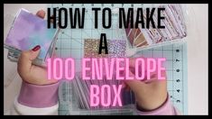 a person holding a cell phone in their hand with the words how to make a 100 envelope box