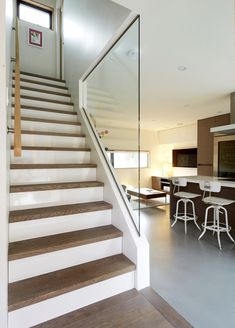 there is a staircase leading up to the kitchen and living room in this modern home