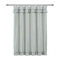 a green and white checkered curtain hanging on a rod