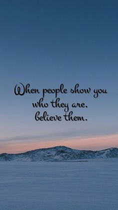 a person standing in the snow with a quote on it that says, when people show you who they are, believe them