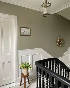 an entryway with stairs and a potted plant