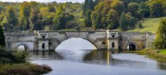 an old stone bridge over a body of water