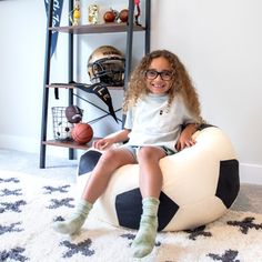 Score big with a bean bag chair that reps your favorite sport! This unique and playful design adds a sporty touch to any room, while being a comfortable and supportive seat. Its cozy plush fabric and fun detailing that looks like a soccer ball, football, or basketball will make you feel like the MVP of your home! Upholstery Color: Soccer Ball | Big Joe Sports Ball Bean Bag Chair, Soft Polyester, 2.5 Feet 16.0 H x 30.0 W x 26.0 D in white / black / brownPolyester in Soccer Ball | Small | Wayfair Faux Fur Bean Bag, Ball Football, Kids Bean Bags, Tv Design, Sports Room, Kids Soccer, Sports Balls, Bag Chair, Plush Fabric