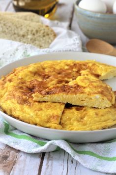 an omelet on a plate with eggs in the background