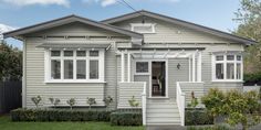 a gray house with white trim and windows