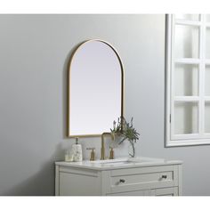 a bathroom vanity with a mirror and two faucets on it's side