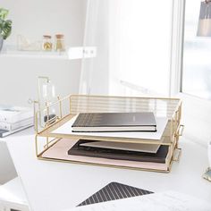 a white desk topped with lots of books