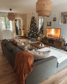 a living room filled with furniture and a christmas tree in the middle of the room