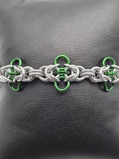 A fun Chainmaille weave that looks like cute little bugs flying over your wrist! Can be made to different lengths, just message me for any adjustments! Hypoallergenic Metal Chain Bracelet For Friendship, Handmade Adjustable Link Chain Bracelet, Adjustable Green Metal Bracelets, Green Adjustable Chain Bracelet, Handmade Adjustable Chain Link Bracelets, Handmade Adjustable Chain Link Bracelet, Chain Maille Patterns Tutorials, Clutter Necklace, Chainmaille Jewelry Patterns