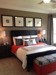 a bedroom with a large bed and pictures on the wall above it's headboard