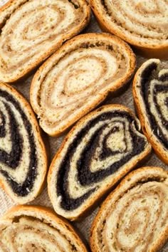 several pieces of bread with black and white swirls on them sitting on a piece of parchment paper