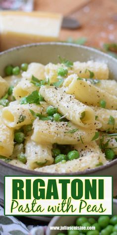 a bowl filled with pasta and peas on top of a table