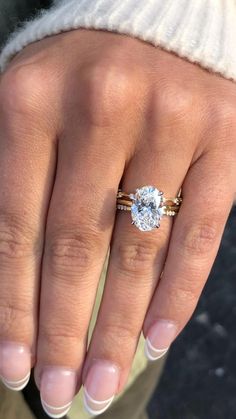 a close up of a person's hand with a ring on their finger and a diamond in the middle