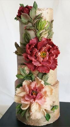 a three tiered cake with flowers on it