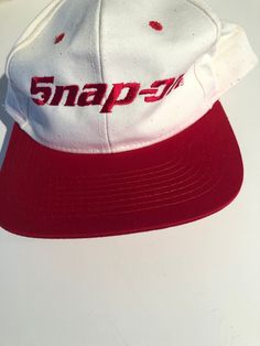 Snap-On White and Red Baseball Hat Adjustable  SnapBack There is some red face on the white along the brim and sides Purchase price includes free shipping in Canada and USA International shipping is available, please contact before purchase for shipping quote Any questions, just ask!  Vintage item, regular wear due to age should be expected Any known flaws/ markings will be listed No returns/ exchanges,  it please contact if there is an issue with your item Vintage White Flat Brim Hat, Retro Red Visor Baseball Cap, Vintage Red Flat Bill Baseball Cap, Red Visor Hat For Streetwear, Vintage Red Snapback Fitted Hat, Retro White Visor Hat, Vintage White Baseball Cap With Curved Brim, Vintage White Baseball Cap For Streetwear, Retro White Fitted Hat With Curved Brim