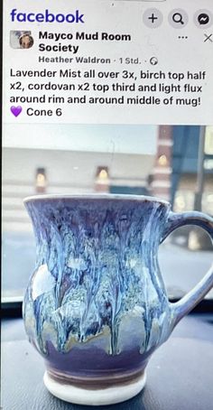 a blue and white cup sitting on top of a table