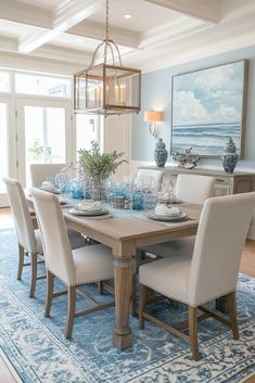 the dining room table is set with blue and white dishes