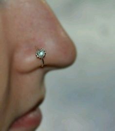 a woman's nose with a tiny ring on it