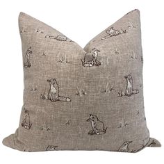 a gray pillow with animals on it