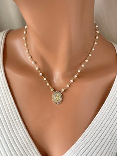 This 14k gold-filled Virgin Mary pendant necklace with freshwater pearls approximately 3-3.5mm.  Spring clasp on back.  Mary pendant measures 23x19mm and has clear pave crystals. Model is wearing a 16"  length in photos. Necklace comes in many lengths, choose your length.  Comes in a gift box ready to present! ALMOST OUT OF STOCK White Miraculous Medal Necklace For Wedding, White Pearl Necklace For First Communion, Catholic Jewelry Necklace, Necklace Choker Gold, Scapular Necklace, 14kt Gold Jewelry, Pearl Necklace Choker, Virgin Mary Necklace, Clean Sterling Silver