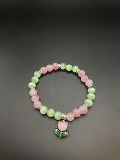 Trendy green and pink tulip bracelet. All my bracelets are elasticated, durable and will fit a variety of wrist size whilst making a lovely gift or treat for yourself. They will be delivered packaged in an organza bag. Will add a pop of colour and an elegant touch to any outfit! Aesthetic Breslet, Cute Bracelets Bead, Cute Bead Bracelets Aesthetic, Beaded Bracelets Aesthetic Y2k, Green And Pink Bracelet, Cute Pink Bracelets, Bracelet Beads Design, Pulseras Coquette, Green Bracelet Beads