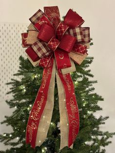 a christmas tree with a red and tan bow