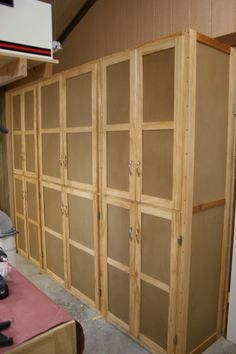 an unfinished room with wooden shelves and tools