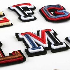 the letters are made up of different colors and sizes, including red, white, and blue