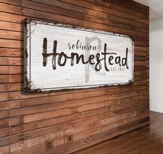 a wooden wall with a sign that says homefead on it and the words