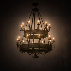 a chandelier with lit candles hanging from it