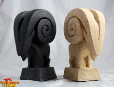 two carved stone sculptures sitting next to each other