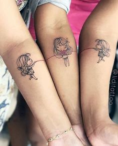 two girls with matching tattoos on their arms are holding each other's hands together